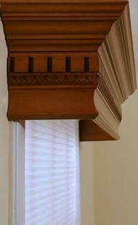 a clock on top of a window sill in a room with white walls and blinds