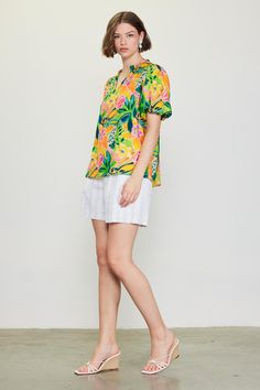 Do the bright thing in this statement-making top. With an artful floral print and bubble sleeves, it's a real mood booster. •Split neckline •Ruffle trim •Puffed short sleeves •Relaxed fit Item Number: 45552 Casual Floral Print Short Sleeve Top For Summer, Vibrant Short Sleeve Relaxed Fit Tops, Green Puff Sleeve Blouse For Summer, Summer Short Sleeve Tops With Vibrant Print, Green Short Sleeve Top For Spring, Vibrant Bold Print Short Sleeve Tops, Summer Puff Sleeve Short Sleeve Top, Multicolor Relaxed Fit Short Sleeve Blouse, Casual Short Sleeve Top With Bold Print