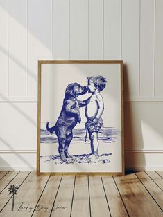 a blue and white drawing of two children playing with a dog on the beach in front of a wooden frame