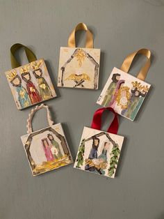 four small paper bags with paintings on them