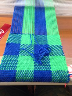 a blue and green blanket sitting on top of a table