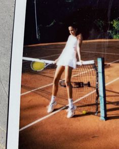 a woman standing on top of a tennis court holding a racquet