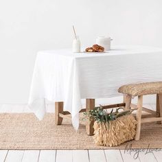 White linen table cloth on a wood table in room with white walls and seagrass rug Natural Linen Tablecloth, Linen Tablecloths, Linen Curtain Panels, Wedding Tablecloths, Custom Napkins, Tablecloth Fabric, Linen Duvet Covers, European Linens, Rectangle Table