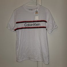 Nwt Calvin Klein Brilliant White Striped Logo Tee Calvin Klein White Logo Print T-shirt, Calvin Klein White Relaxed Fit T-shirt, White Calvin Klein Crew Neck T-shirt, Calvin Klein White Crew Neck T-shirt, Spring Calvin Klein Crew Neck Top, White Calvin Klein Cotton T-shirt, White Cotton Calvin Klein T-shirt, Calvin Klein White Short Sleeve Top, Sporty Calvin Klein Tops With Logo Print