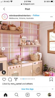 a pink and white kitchen with lots of shelves