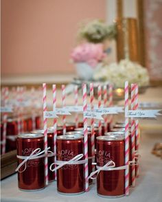 there are many red and white striped straws in mason jars