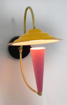 a yellow and pink lamp on a white wall