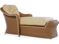 a brown wicker chaise lounge chair with white cushions