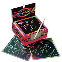 a box with some writing on it and a pair of scissors in the top one