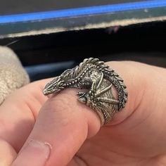 This beautiful Dragon ring is cast in 925 silver and shipped inside a beautiful stained wooden box. This ring is adjustable but please verify ring size so I can send you a ring that fits properly. Per the photos, some parts of this ring can be sharp and get caught on clothing. These rings are all handmade to order so each ring may have slight differences. Handmade in the USA of 925 silver. Also available in 24k gold plated! This is pure 24k gold that is plated to a thickness of 1 micron. minimum jewelry standard is 0.5 microns so I do double for longevity. Check out my YouTube channel for how the process works. Please verify ring size before ordering. Resizing is not possible for custom rings. Returns will only be accepted within 7 days of receipt and with receipt of the original price in Unique Sterling Silver Snake Ring As Gift, Spiritual Carved Rings As Gift, Collectible Symbolic Sterling Silver Snake Ring, Sterling Silver Snake Ring Collectible Symbolic, Sterling Silver Symbolic Snake Ring Collectible, Unique Carved Rings As Gifts, Unique Carved Rings For Gifts, Unique Rings With Lost Wax Casting As Gift, Adjustable Engraved Snake Ring Gift