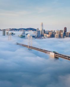 the bay bridge is surrounded by fog in san francisco