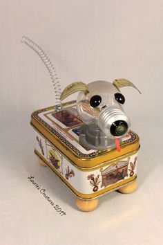 a toy dog in a tin can with its mouth open