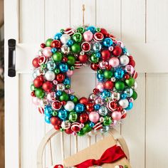 a wreath is hanging on the door with ornaments