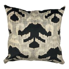 a black and white pillow with an abstract design on the front, sitting on a white background