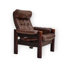 a brown leather chair sitting on top of a wooden frame