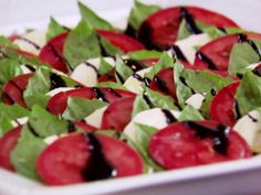 a close up of a plate of food with tomatoes and cheese