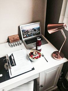 an open laptop computer sitting on top of a white desk