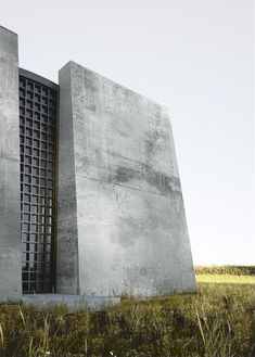 two tall concrete buildings sitting on top of a lush green field