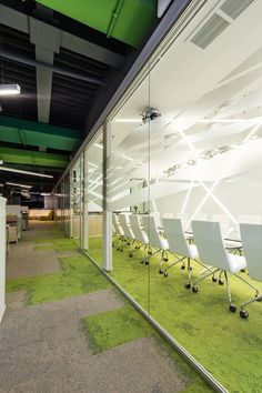 an office with green carpet and white chairs