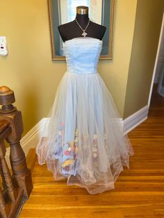 50's style light blue tulle dress. Size 10. Strapless fit and flare. Someone went to a lot of work to add silk faux flowers underneath the tulle. Wonderful for a special event, photoshoot or retro pageant! Interested in more than 1 item from OperaKittyCo?  I do combined shipping, meaning I package your items together and refund the shipping overage! Vintage Tulle Skirt Dress For Party, Vintage Tulle Dress For Party, Vintage Fitted Tulle Dress, Fitted Vintage Tulle Dress, Fitted Vintage Tulle Skirt Dress, Vintage Tulle Dress For Spring, Vintage Tulle Dresses For Spring, 1950s Style Blue Wedding Dress, 1950s Style Spring Wedding Dresses