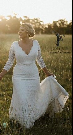 a woman in a white dress is walking through the grass with her hands behind her back