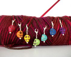 a spool of yarn with skulls on it and some beads hanging from the end