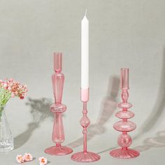 pink glass candlesticks and vase with flowers