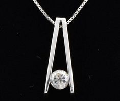 "Please like our Facebook page at https://www.facebook.com/artmanjewelry/ SOLITAIRE PENDANT IN 10 KARAT WHITE GOLD WITH ONE SINGLE .25 CARAT CUBIC ZIRCON. metal---10 karat white gold set-bezel set finish----high polish FOR ADDITIONAL QUESTIONS ABOUT THIS PRODUCT: Please feel free to message us. We are quick to respond to all your inquiries. PLEASE choose as \"FAVORITE\" on the right so the item will be added to your favorites list and you may always revisit it. CUSTOM ORDERS: Please feel free to Necklace White Gold, Solitaire Diamond Pendant, Diamond Pendants Designs, Fancy Design, White Gold Necklace, Fancy Necklace, White Gold Pendant, Solitaire Pendant Necklace, Big Diamond