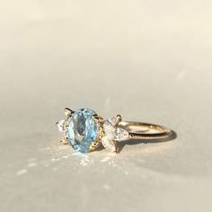 Pastel blue topaz accented with sparkle marquise cut earth mined diamonds makes this ring a breeze in the hot summer! *Stone info:   1pc of 8x6 oval cut sky blue topaz   6pcs of 4x2 marquise cut natural diamonds, G-H/SI quality *Topaz ct weight: approx. 1.6ct * Diamond ct weight: approx. 0.42ctw *Total ct weight: approx. 2.02ct. *Band thickness: 1.3mm * Metal: 14K Yellow Gold * Stamp: 14K ❤️Visit our official website for exclusive new products.      https://elekalonjewelry.com/ ❤️Follow us on In Diamond And Topaz Ring, Diamond And Blue Topaz Engagement Ring, Blue Topaz And Diamond Ring, Light Blue Oval Diamond Topaz Ring, Oval Blue Topaz Ring With Diamond Accents, Oval Aquamarine Diamond Ring With Accents, Oval Topaz Ring With Aquamarine And Gemstone Accents, Oval Aquamarine Diamond Ring With Diamond Accents, Oval Topaz Ring With Diamond And Gemstone Accents