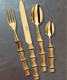 three forks, two spoons and one knife on a table