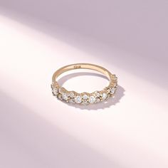 a gold ring with five diamonds on it