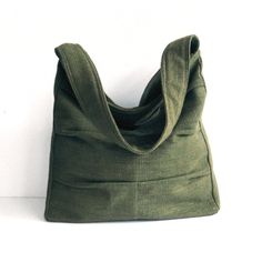 Please check 'shop announcement' for production time and delivery before your purchase.  This gorgeous bag is made from forest green pure hemp material. I really love its unique texture and the ruggedness of hemp, giving you a different feeling from other kinds of fabric. This everyday bag is sturdy and roomy enough to hold your essentials, such as books, wallet, Ipad, mobile and keys. It's fully lined with canvas, there are 2 slip pockets, one zipper pocket  and a pen slip inside. The strap has been interfaced with poly-fleece for your extra comfort.  A zipper closure keeps all of your items secure. If you prefer this bag to be with a magnetic snap please let me know. You can select the colors from the option menu in this listing. I make each bag individually by hand with lots of care, so Green Hobo Satchel Bag With Pockets, Eco-friendly Green Hobo Bag For Travel, Green Satchel Hobo Bag With Pockets, Green Canvas Satchel Bag For Everyday Use, Olive Rectangular Shoulder Bag For Daily Use, Green Canvas Satchel Bag, Green Canvas Shoulder Bag Gift, Green Canvas Bag With Removable Pouch For Everyday, Green Square Hobo Bag For Everyday Use