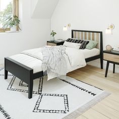 a bedroom with white walls and wooden floors