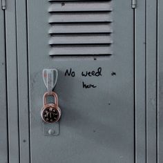 there is a lock on the side of a locker with writing on it and a padlock