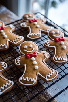 several decorated ginger cookies on a cooling rack