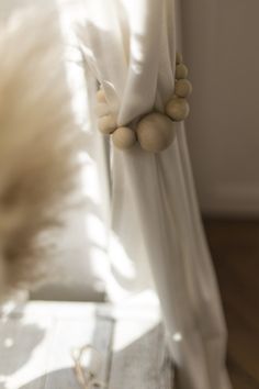 a white curtain with beads hanging from it