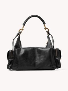 Chloé's Large Camera bag is crafted from natural shiny buffalo leather. Its multiple pockets are embellished with revamped buckles from the iconic Paddington bag. Carry the Camera bag in the hand, on the shoulder or cross-body with the handles or strap. Product Details Designer ID: CHC24AS532N83001 Color: Black Composition: Main material: Buffalo leather; Flap lining: Buffalo leather; Main lining: 54% Cotton, 46% Linen Width: 16.9" (43 cm); Height: 7.9" (20 cm); Depth: 8.3" (21 cm); Handle drop: Luxury Shoulder Bag With Gunmetal Hardware And Double Handle, Luxury Hobo Shoulder Bag With Gunmetal Hardware, Leather Shoulder Bag With Metal Hardware And Double Handle, Luxury Hobo Bag With Metal Hardware And Double Handle, Designer Shoulder Bag With Palladium Hardware And Double Handle, Luxury Satchel With Gunmetal Hardware, Luxury Crossbody Hobo Bag With Gunmetal Hardware, Luxury Hobo Bag With Gunmetal Hardware Crossbody, Luxury Hobo Bag With Gunmetal Hardware In Tote Shape