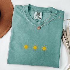 Comfort Colors Sun T-Shirt, Embroidered Sunshine Shirt, Embroidered Sun Shirt, Simple Embroidered Suns Shirt, Cute Embroidered Shirt This embroidered Suns shirt is everything. Perfect to wear or give to your loved one.  Please let me know if you are interested in a size 4X, I have certain size and color options available! ✨ 100% Cotton ✨ Pre-shrunk ✨ Relaxed fit Care: Machine wash: warm (max 40C or 105F) Tumble dry: low Do not iron directly on the design REFUNDS AND EXCHANGES All items are made Green Cotton Shirt With Floral Embroidery, Embroidered Long Sleeve T-shirt For Summer, Casual Embroidered T-shirt For Summer, Casual Crew Neck Shirt With Machine Embroidery, Relaxed Fit Cotton Top With Machine Embroidery, Cotton Tops With Machine Embroidery And Relaxed Fit, Casual Relaxed Fit T-shirt With Machine Embroidery, Green Cotton Tops With Machine Embroidery, Casual Cotton Shirt With Machine Embroidery