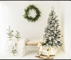 a white room decorated with christmas trees and rocking horse