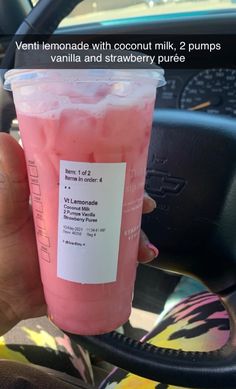 a person holding up a pink drink in their hand with the caption'veni lemonade with coconut milk, 2 pumps vanilla and strawberry puree