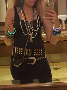 a woman taking a selfie in front of a mirror