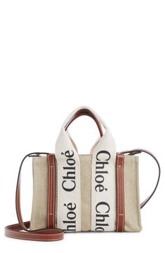 Chloé's classic logo stands out at the sturdy straps of this scaled-down tote in linen canvas set off with topstitched leather trim. The style comes with a crossbody strap for the option of hands-free carry. Open top Top carry handle; removable, adjustable crossbody strap Interior card slot Structured silhouette with flat base for stability Unlined Textile with leather trim Made in Italy Designer Handbags This brand has B Corp certification, representing business practices with emphasis on socia Louis Vuitton Shop, Linen Canvas, Mini Tote Bag, Top Top, Classic Logo, Mini Tote, Canvas Set, White Bag, Crossbody Strap