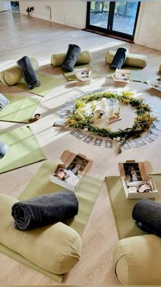 yoga mats laid out on the floor with pictures and candles arranged around them in a circle