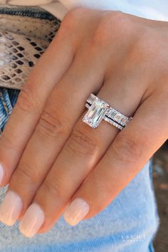 A magnificent engagement ring. Showcasing a perfect emerald cut diamond, set in a thin delicate diamond band solitaire ring, next to a custom emerald cut diamond eternity band. Emerald Diamond Engagement Ring With Wedding Band, Emerald Ring With Band, Rectangle Wedding Ring Stack, Rectangle Engagement Ring With Diamond Band, Emerald Engagement Ring Pave Band, Wedding Bands That Go With Emerald Cut, Rectangle Ring With Wedding Band, Emerald Engagement Ring Cut With Band, Emerald Engagement Ring With Band Wedding Set