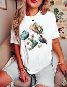 Keywords: Watercolor Flower Tee, Summer Shirt, Flower Lover Shirt, Nature lover Shirt, Floral Shirt, Ladies Top, Best friend gift, Wildflower tshirt. Introducing our latest floral masterpiece - the Watercolor Flower Shirt. This stunning design is sure to turn heads with its beautiful flowers in a soft and delicate watercolor style. Crafted from premium quality materials, this shirt is both lightweight and comfortable, making it perfect for any occasion. The breathable fabric ensures maximum comfort, while the flattering cut and stylish design make it a versatile addition to any wardrobe. Indulge in the utmost comfort and style with our BlendedApprl Unisex T-shirts. Crafted with premium quality, these tees are incredibly soft and cozy to wear. They are made from a blend of 100% cotton for s White Relaxed Fit T-shirt With Watercolor Print, White Watercolor Print Short Sleeve T-shirt, Casual White T-shirt With Watercolor Print, White Watercolor Print T-shirt For Spring, White Watercolor Print Short Sleeve Top, Cute White T-shirt With Plant Print, Floral Print Relaxed Fit Tops As Gift, Multicolor Tops For Spring As A Gift, Short Sleeve Tops For Spring