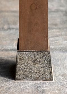 a wooden object sitting on top of a stone floor