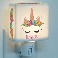 a night light with an unicorn face and flowers on it's head that says, harper