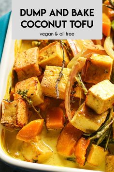 a white dish filled with tofu and vegetables on top of a blue table cloth