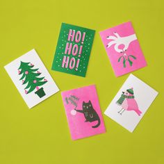 four christmas cards on a green background