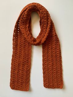 Crochet textured wrap scarf. Crafted from premium acrylic yarn, in pumpkin orange. Created in my signature textured lacy stitch pattern. A must have this coming fall and winter. Makes a wonderful and unique gift. Created free form, without a pattern, making this a OOAK (one of a kind) luvbuzz original! Exact measurements given below.  Ready to ship! MEASUREMENTS: -Length: 68"  -Width: 5" CARE: ❤️Machine or hand wash in mesh laundry bag, with like colors. Lay flat or tumble dry on lowest heat setting. Hand-knitted Yarn Scarves For Fall, Hand Knitted Yarn Scarves For Fall, Brown Yarn Scarf For Fall, Fall Crochet Yarn Scarf, Crochet Acrylic Yarn Scarves For Fall, Fall Crochet Scarves In Acrylic Yarn, Fall Crochet Scarf In Acrylic Yarn, Fall Crochet Acrylic Scarves, Pumpkin Crochet